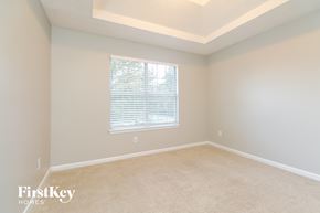 Stockbridge house for rent - a bedroom with a large window and a carpeted floor