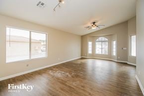 Phoenix house for rent - A spacious room with wooden floors and a ceiling fan.