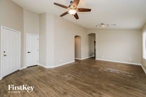 Phoenix house for rent - A spacious room with a ceiling fan and wooden flooring.