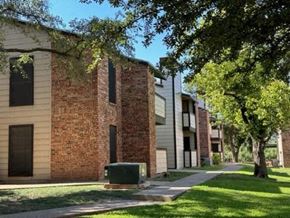 San Angelo apartment for rent - a brick building with trees in front of it