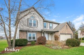 Fishers house for rent - A house with a well-maintained lawn and a fence in front.