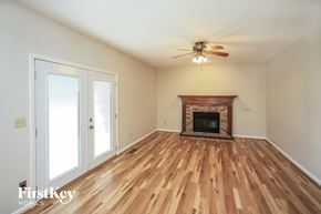 Fishers house for rent - A room with a fireplace and wood flooring.