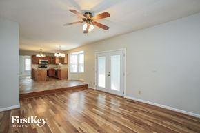 Fishers house for rent - A spacious room with a ceiling fan and wooden flooring.