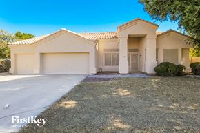 Avondale house for rent - a white house with a driveway and a garage door