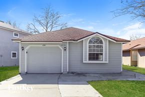 Jacksonville house for rent - a white house with a white garage door and a window