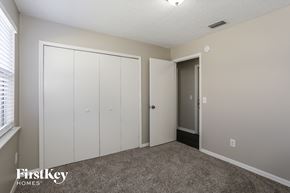 Jacksonville house for rent - a bedroom with two closets and a door to a hallway