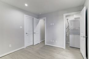 Houston apartment for rent - A white refrigerator is in the corner of a kitchen.