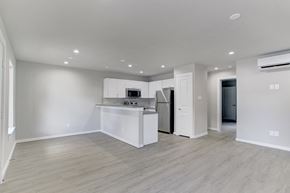 Houston apartment for rent - A kitchen with white cabinets and a wooden floor.