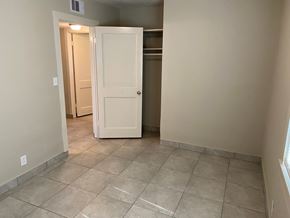 Bay City apartment for rent - an empty hallway with a white door and tiled floor