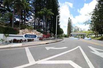 Honolulu apartment for rent - A road with a sign that says "Originalz" in front of a forest.