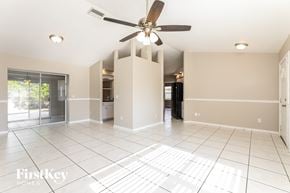 North Port house for rent - an empty kitchen and living room with a ceiling fan