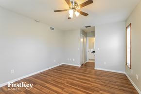 North Port house for rent - a living room with wood flooring and a ceiling fan