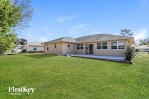 North Port house for rent - a house with a grassy yard and a driveway