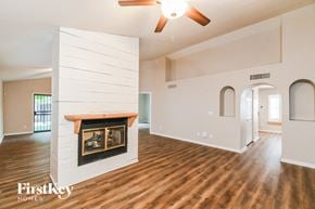 Gilbert house for rent - A spacious living room with wood floors and a fireplace.