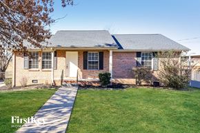 Lebanon house for rent - A brick house with a white door and a small front yard.
