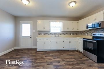 Lebanon house for rent - A kitchen with wooden floors and white cabinets.