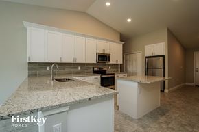 Lehigh Acres house for rent - a large kitchen with white cabinets and granite counter tops