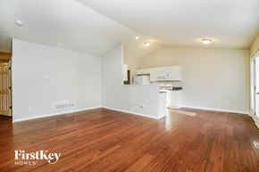 Reynoldsburg house for rent - an empty living room with wood flooring and a kitchen