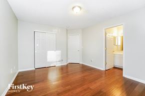 Reynoldsburg house for rent - a living room with a hard wood floor and a door to a bathroom
