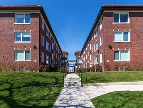 St. Louis apartment for rent - A long brick building with a walkway in between.