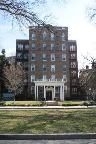 Woodmere apartment for rent - a large brick building with a lawn in front of it