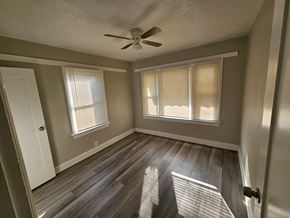 Whittier apartment for rent - a living room with wood floors and a ceiling fan