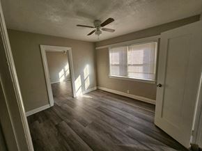 Whittier apartment for rent - an empty living room with wood floors and a ceiling fan