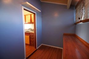 Mililani apartment for rent - A room with a blue wall and a wooden floor.
