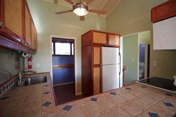 Mililani apartment for rent - A kitchen with a refrigerator and a ceiling fan.
