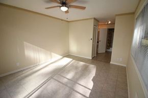 Mililani apartment for rent - A room with a ceiling fan and light, tiled floor, and a doorway leading to another room.