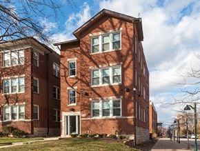 St. Louis apartment for rent - A red brick building with a white door and windows.