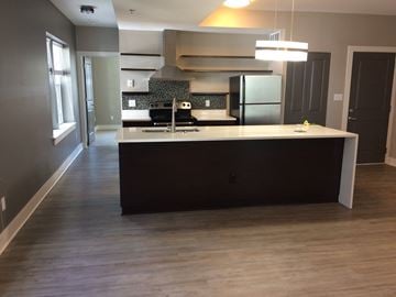 St. Louis apartment for rent - A kitchen with a large island and a refrigerator.