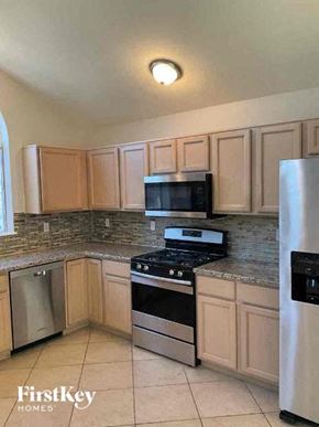 Oro Valley house for rent - a kitchen with stainless steel appliances and wooden cabinets
