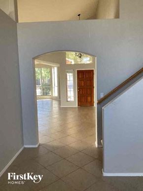 Oro Valley house for rent - a hallway with a door to a living room and a staircase