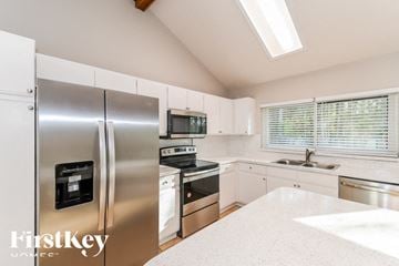 Jacksonville house for rent - A kitchen with a stainless steel refrigerator and a stainless steel sink.