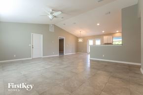 Pt Charlotte house for rent - A spacious room with a fan and tiled flooring.