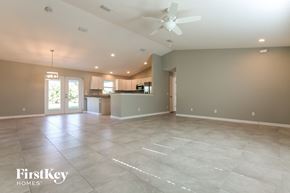 Pt Charlotte house for rent - A spacious empty room with a ceiling fan and lighting fixtures.