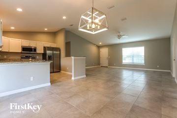 Pt Charlotte house for rent - A spacious kitchen and living room with a large island and a ceiling fan.