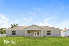 Pt Charlotte house for rent - A house with a white exterior and a brown roof is for sale.