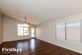 Surprise house for rent - A room with wooden floors and a ceiling fan.