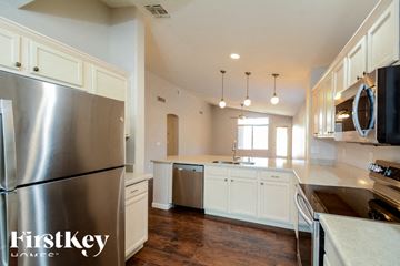 Surprise house for rent - A modern kitchen with a stainless steel refrigerator and wooden floors.