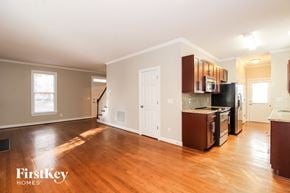 Greensboro house for rent - A kitchen with wooden floors and a white door.