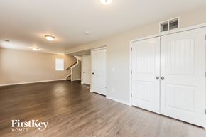 Colorado Springs house for rent - an empty living room with white closets and wood flooring