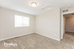 Colorado Springs house for rent - a bedroom with a carpeted floor and a door to a closet