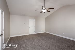 Lawrenceville house for rent - a bedroom with carpet and a ceiling fan