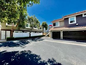 Costa Mesa apartment for rent - A sunny day in a quiet residential street with houses on both sides and a clear blue sky.