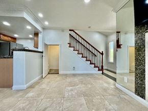 Costa Mesa apartment for rent - A spacious living room with a staircase leading to the upper floor.