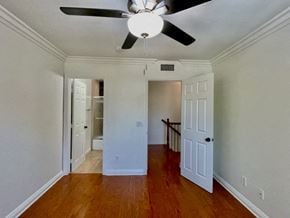 Costa Mesa apartment for rent - A room with a ceiling fan and wooden floors.