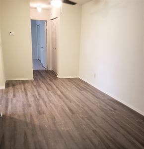 Elkton apartment for rent - an empty living room with wood flooring and white walls