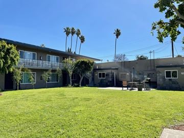 Anaheim apartment for rent - A sunny day at a residential area with houses and palm trees.